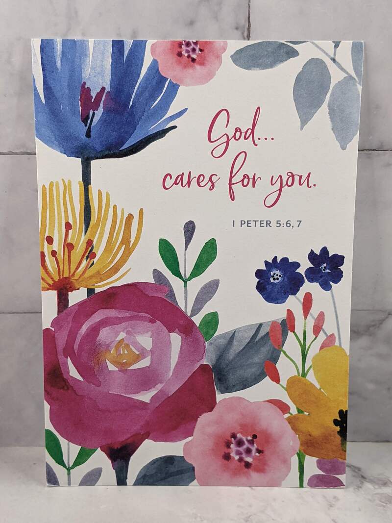 A religious greeting card with a flower design, that has a message of care.