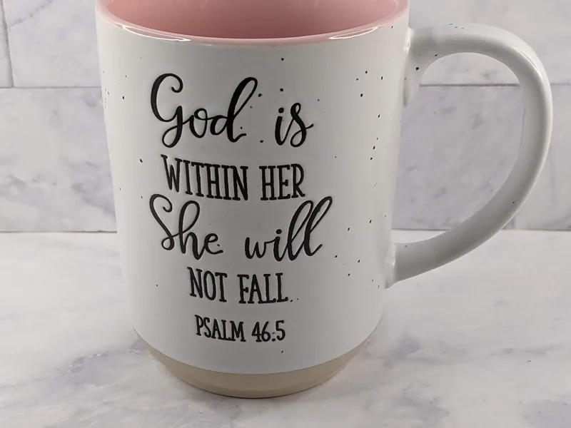 A Christian coffee mug with a Bible Verse "God is within her she will not fall."