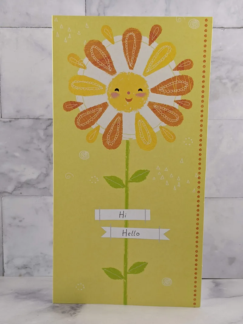 A yellow greeting card wishing someone a sunny day.