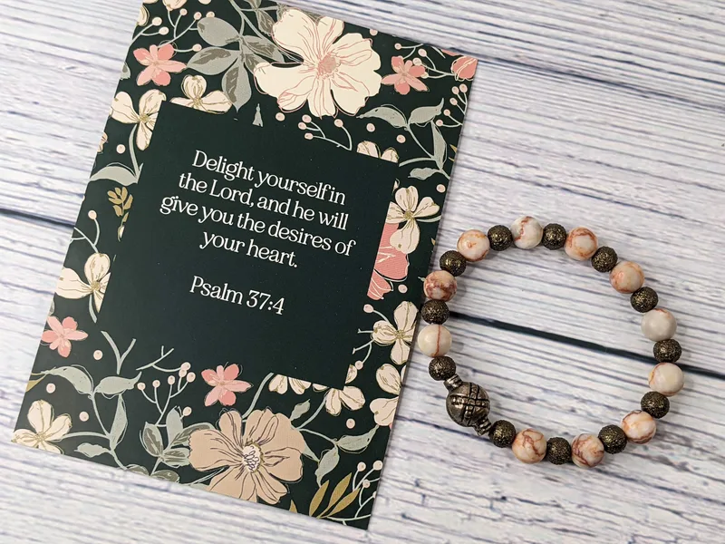 A Bible verse card with a beaded bracelet that has stone and metal beads. Psalm 37:4