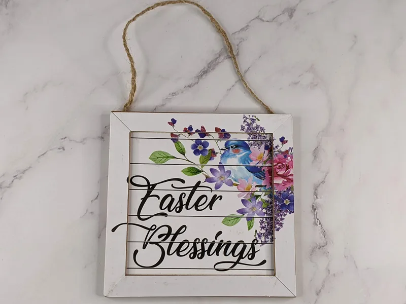 "Easter Blessings" decorative wall sign with a floral design and twine for hanging it.