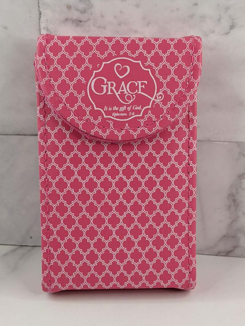 A grace themed manicure set in a pink suede case with a white pattern design.