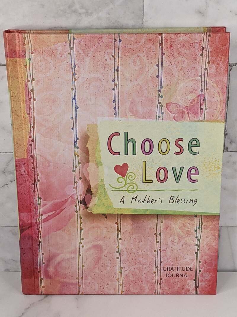 A pink hardcover gratitude journal for a mother, titled Choose Love.