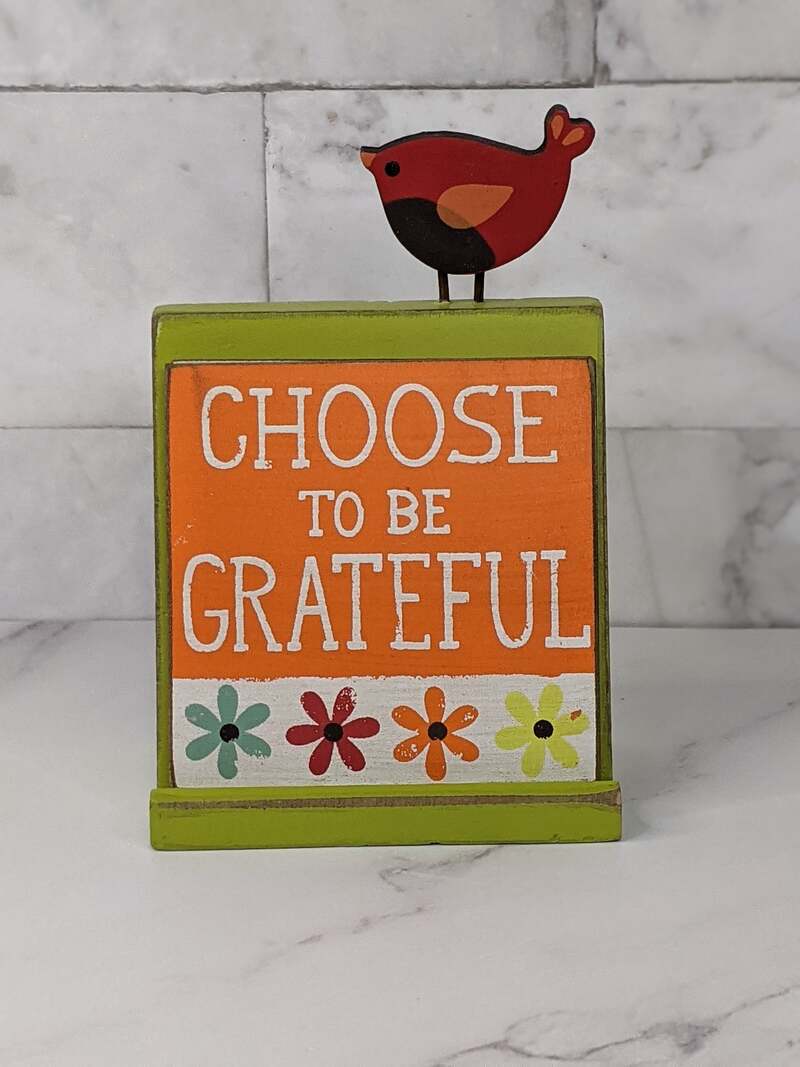 A message block with interchangeable messages of faith, and is designed with a red bird motif above the messages.