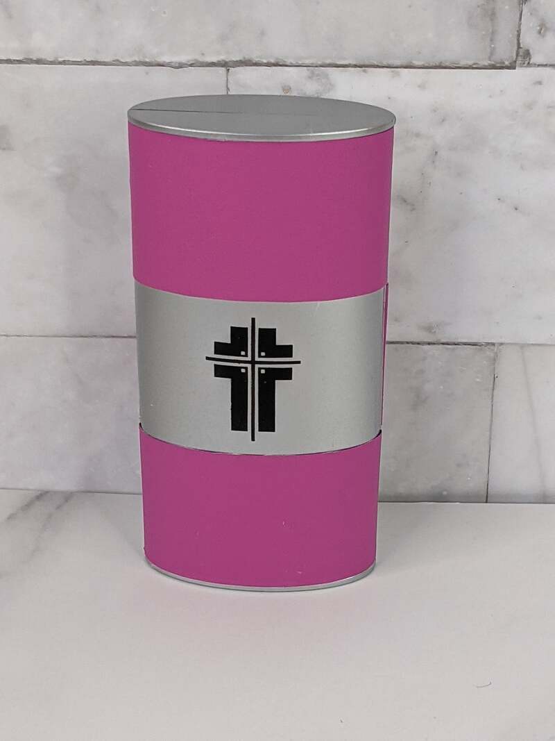 A manicure set in a pink case that features the image of a cross.