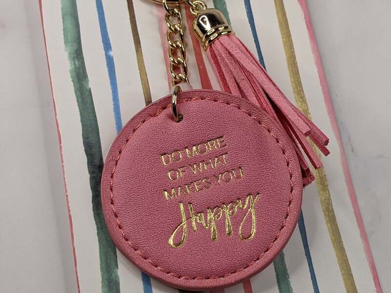 A lovely dark pink leatherette tassel key FOB with gold lettering with an inspirational message.