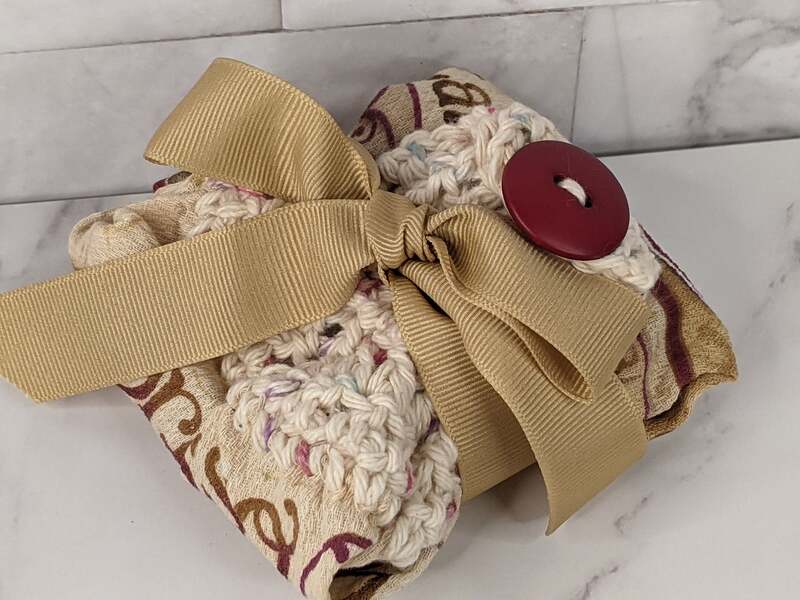 A tan hanging kitchen hand towel with a crocheted towel topper and a coffee shop theme!