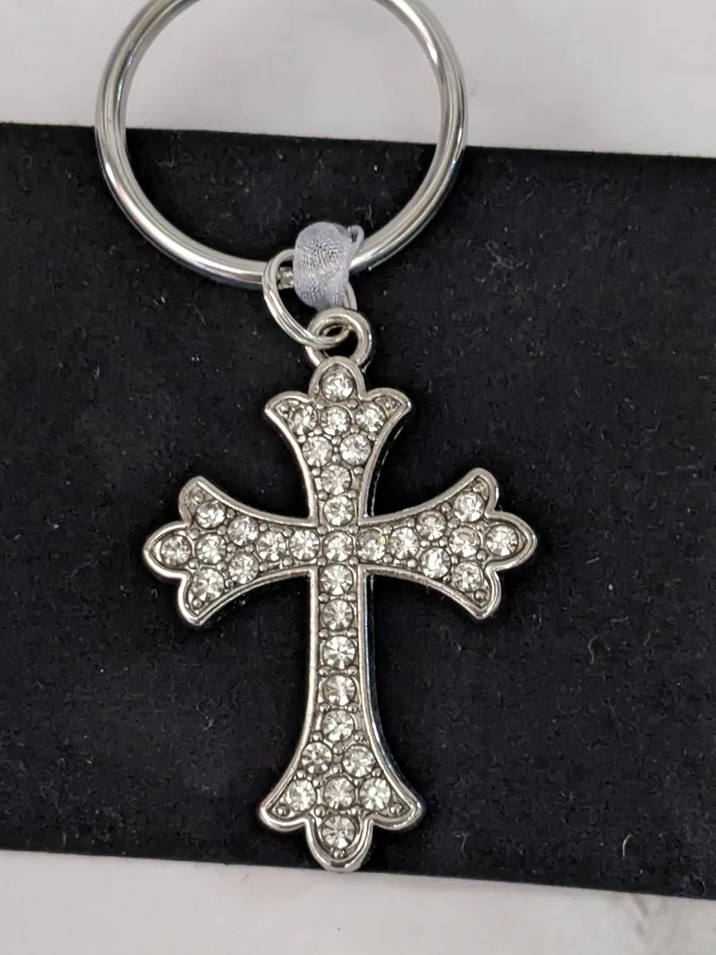 A silver cross keyring with rhinestone accents.
