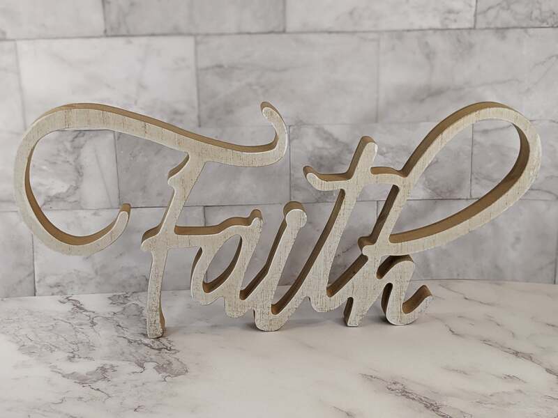 A wood-like cutout word with the message, "Faith."